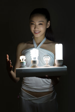 Young woman and a light bulb high quality photoの写真素材
