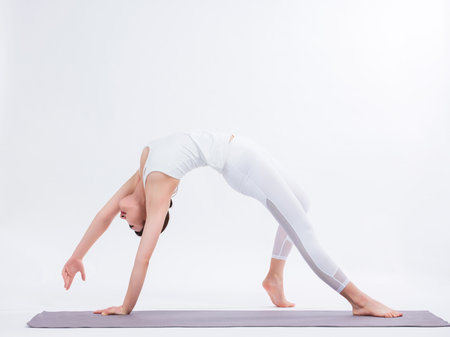 Young women practice yoga with back bendingの写真素材