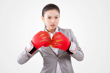 Business woman wearing boxing gloves high quality photoの写真素材