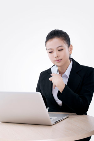 Oriental fashion business woman using laptop high quality photoの写真素材