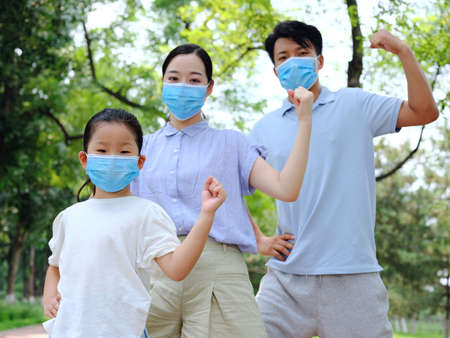 A family of three with masks high quality photo