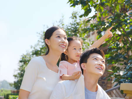 Happy family of three in the outdoor group photo high quality photo