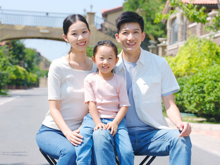 Happy family of three in the outdoor group photo high quality photoの写真素材