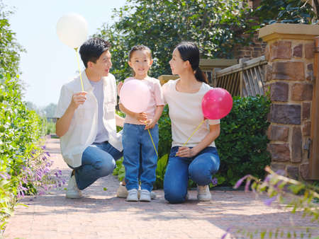 Happy family of three in the outdoor group photo high quality photoの写真素材