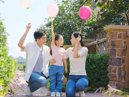Happy family of three in the outdoor group photo high quality photoの写真素材