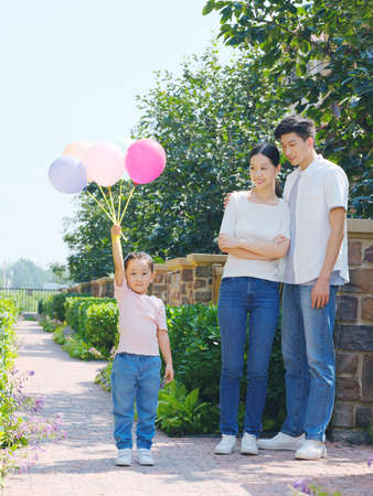 Happy family of three in the outdoor group photo high quality photoの写真素材