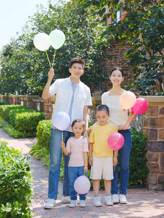 Happy family of four in the outdoor group photo high quality photoの写真素材
