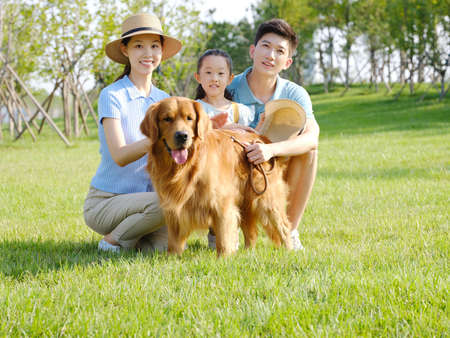 Happy family of three and pet dog in outdoor photo high quality photoの写真素材