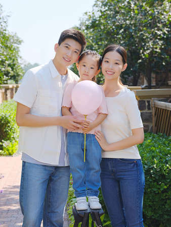 Happy family of three in the outdoor group photo high quality photoの写真素材