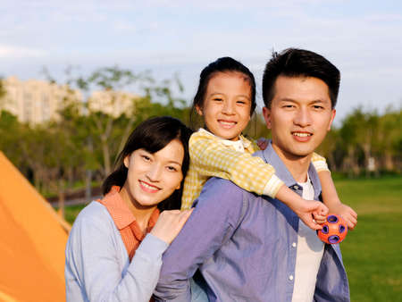 Happy family of three in the park high quality photoの写真素材