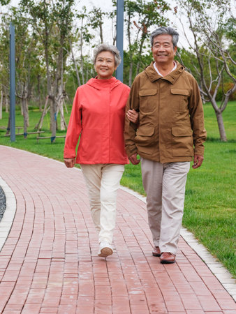 Happy old couple walking in the park high quality photoの写真素材