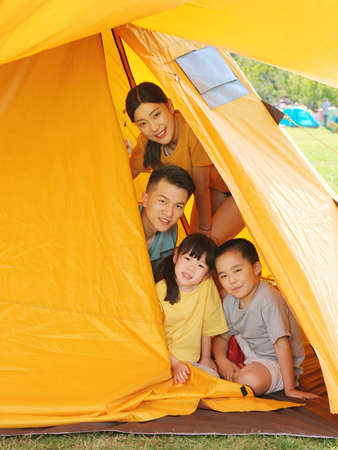 Happy family of four in tent high quality photoの写真素材