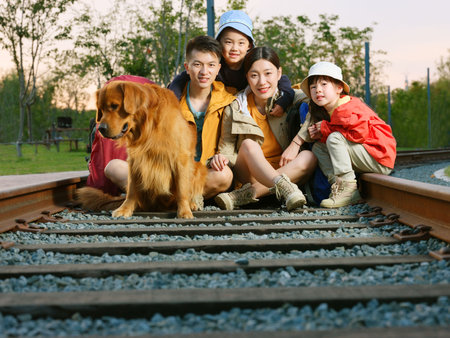 Happy family of four and pet dog in outdoor photo high quality photoの写真素材