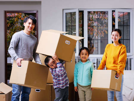 A happy family of four move house high quality photo