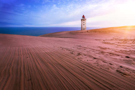 The lighthouse Rubjerg Knude in Denmark at sunriseの写真素材
