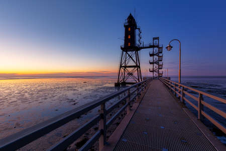 The lighthouse Obereversand near the village Dorum-Neufeld at sunsetの写真素材