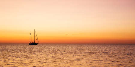 A boat on the Ijsselmeer near the lighthouse Paard van Marken on the dutch peninsula Marken