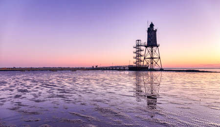 The lighthouse Obereversand near the village Dorum-Neufeld at sunsetの写真素材