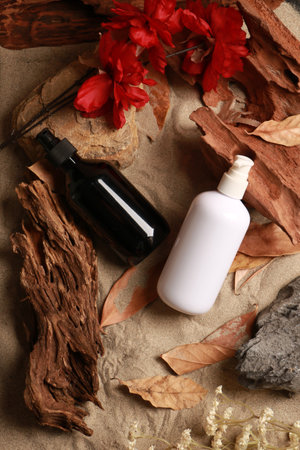 Cosmetic bottle on a background of dried leaves, flowers and woodの写真素材