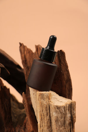 Bottle of serum on wooden background, closeup. Cosmetic productの写真素材