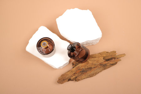 Essential oil bottle on a background of white paper and driftwoodの写真素材