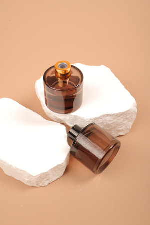 Amber glass bottle with pipette and toilet paper on brown background