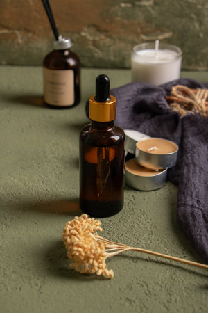 Spa still life with essential oil and candle on textured backgroundの写真素材