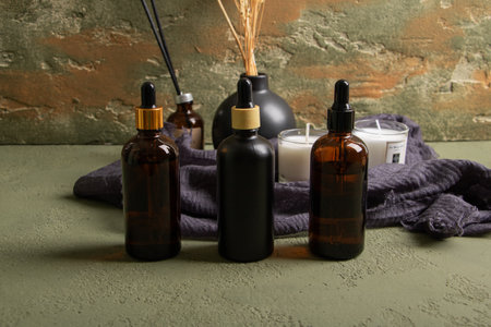 Beautiful spa composition with aroma oils on color background, closeup