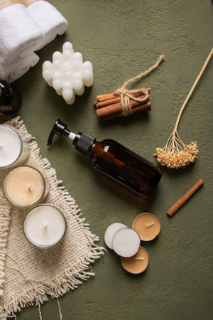 Spa still life with essential oil, candles and towel on color backgroundの写真素材