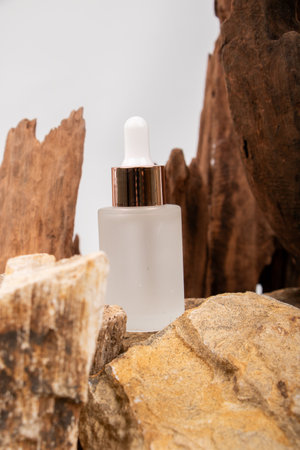 cosmetic bottle with pipette on wooden background, beauty and spa conceptの写真素材