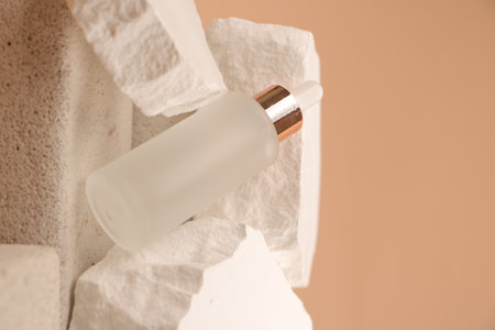 White cosmetic bottle with a pipette on a background of toilet paperの写真素材