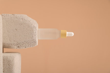 Close-up of a pipette on a beige background.の写真素材
