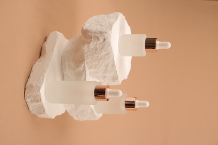 Close-up of white earphones on a beige background.の写真素材
