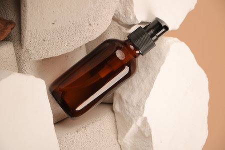 Brown glass bottle with pipette on white paper background, closeupの写真素材