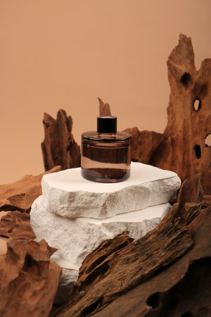 Cosmetic bottle on a white stone podium with wooden log background.