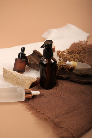 Spa still life with essential oil, towels and soap on brown backgroundの写真素材