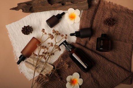 Beautiful spa composition with aroma oil on brown background, top viewの写真素材