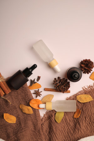 Set of cosmetic products and autumn leaves on color background, top viewの写真素材