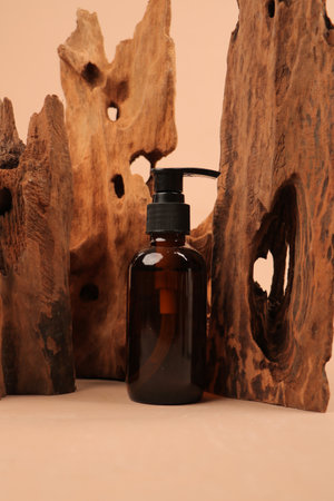 Amber glass dispenser bottle with dropper on a wooden backgroundの写真素材