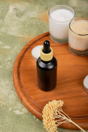 Aromatherapy essential oil in glass bottle on wooden board.の写真素材