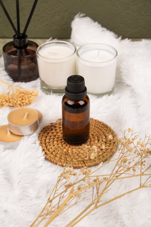 Aromatherapy essential oil in a glass bottle on a wooden backgroundの写真素材