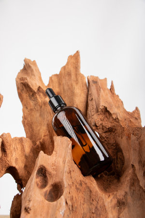 Amber glass dropper bottle with pipette on wooden background.の写真素材