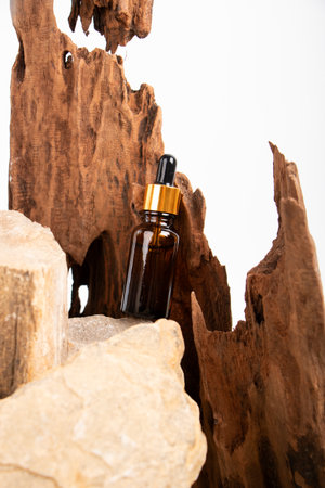 Essential oil in a glass bottle on a wooden background. Natural organic cosmetics.の写真素材