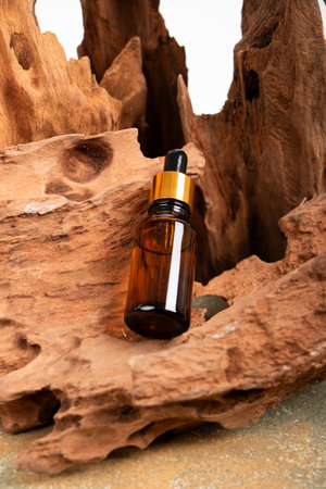 Amber glass dropper bottle with pipette on wooden background.の写真素材