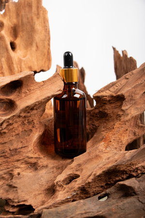 Amber glass bottle with pipette on wooden background. Natural cosmetic conceptの写真素材