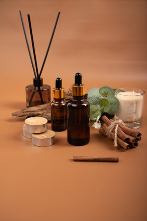 Spa still life with aroma sticks and essential oil on brown background