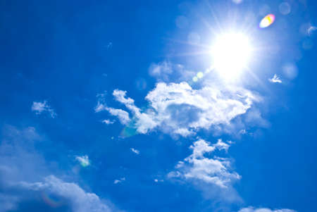 Blue sky and white clouds under the sunの写真素材
