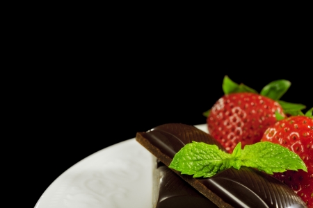 Chocolate & strawberries with mint on black background.の写真素材
