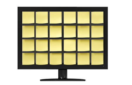 Sleek modern computer monitor covered in organized yellow notes in front of a white background.の写真素材
