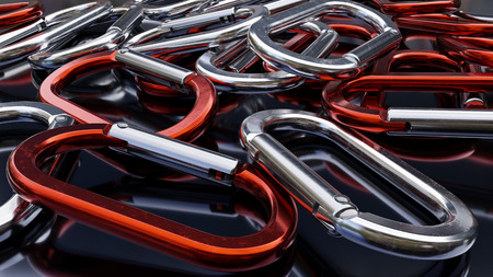 Many red and silver carabiners on a dark reflective background.